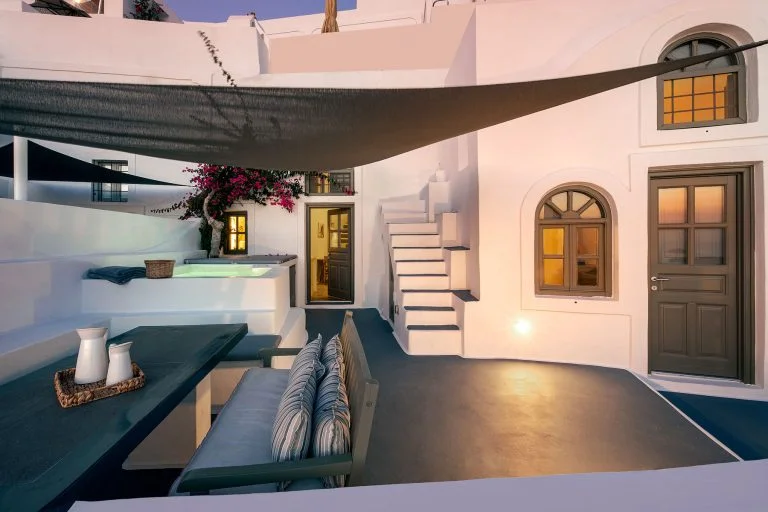 a patio with a table and chairs and a black awning