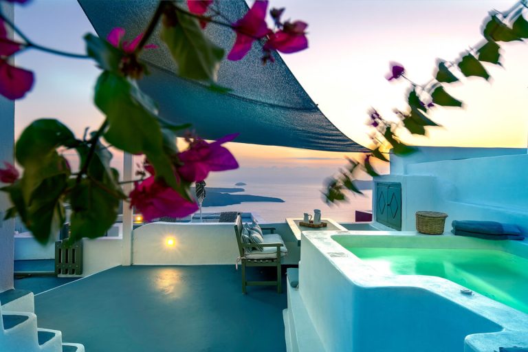 a balcony with a jacuzzi and a view of the ocean